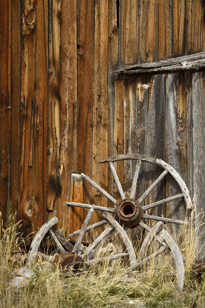 Wagon Wheels Against Old Barn
